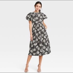 Beautiful classy black and white midi dress with flutter sleeves!